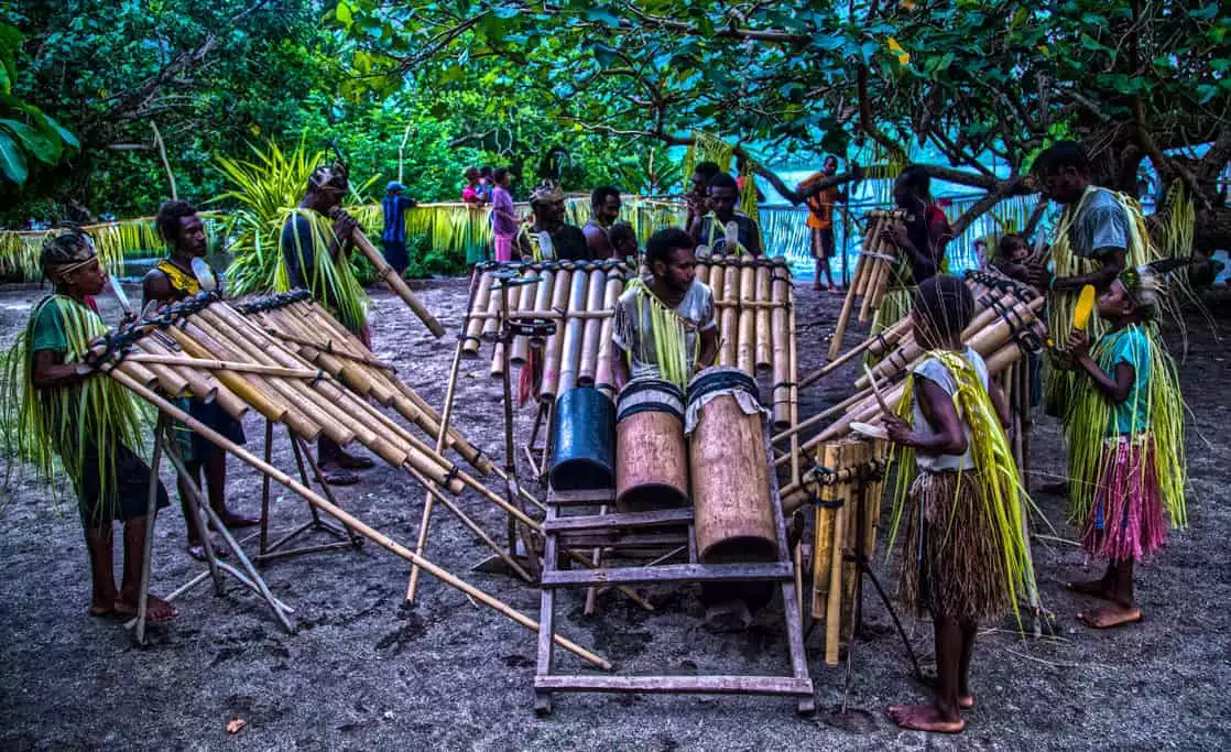 Villagers playing musical instruments on an island in the south pacific. 