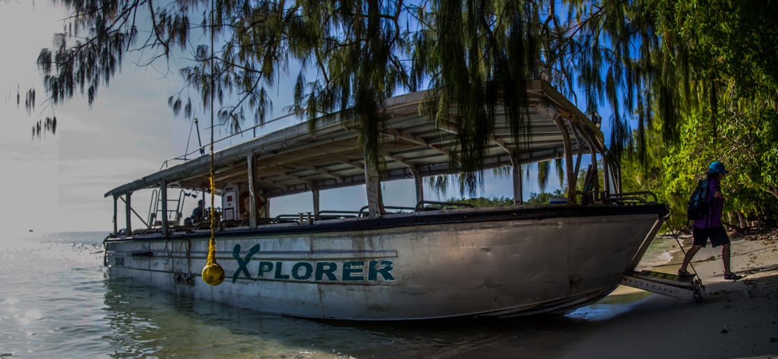 Boat taking small cruise ship guests to the beach in the South Pacific Islands.