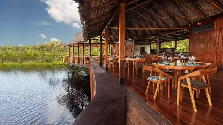 La Balsa Restaurant at the Sacha Lodge in Ecuador with river side seating and views of wildlife and the jungle as you dine