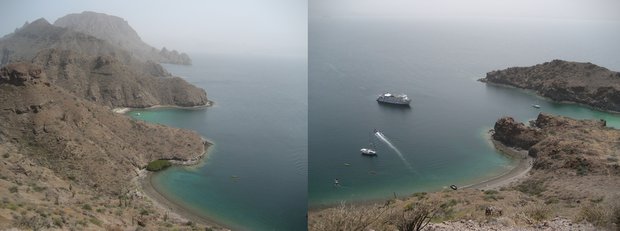 View from a ridge top on a Baja desert island with a small ship cruise and other boats anchored in the water.