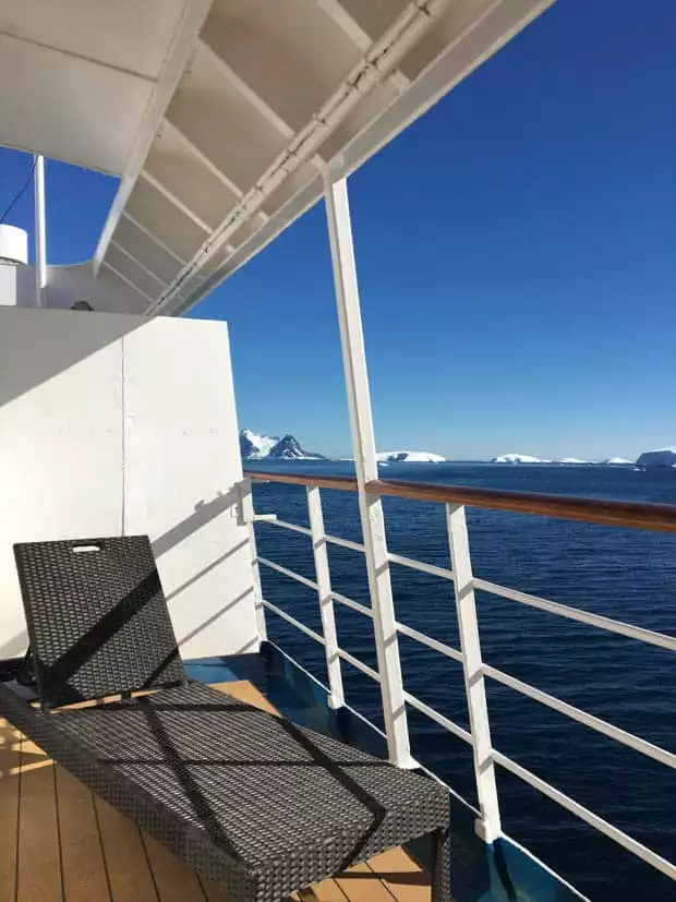 Lounge chair on a Premium Balcony suite cabin aboard a small ship in Antarctica. 