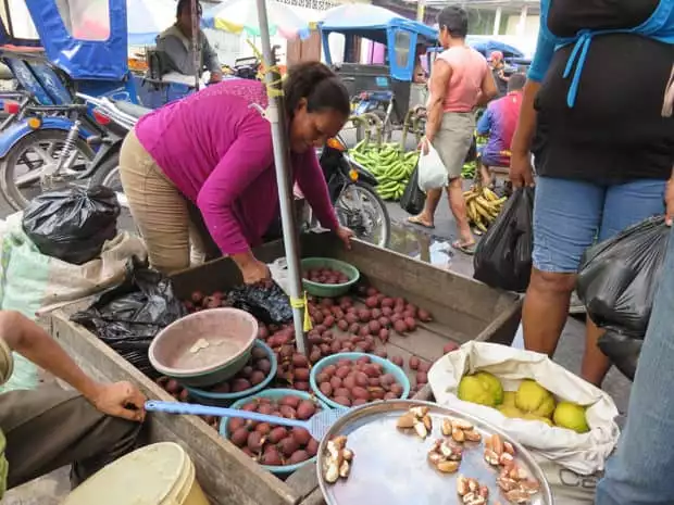 People buying vegetables at the market in Peru. 