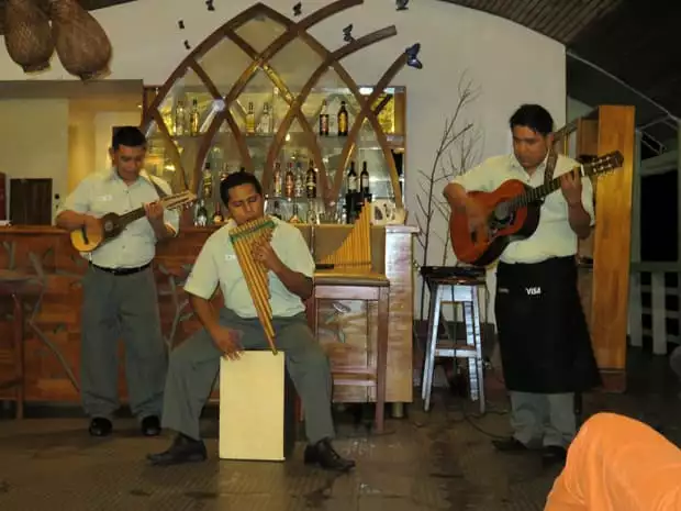 Three crew members of the Amatista playing music. 