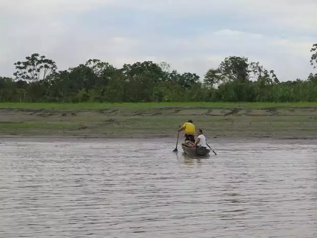 Fisherman in a canoe in the Peruvian Amazon river. 