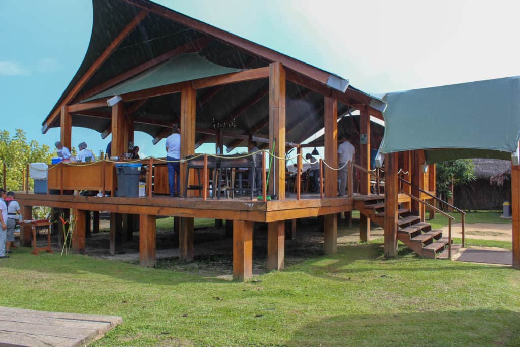 The welcome platform for Aria Amazon travelers with food, shelter and tables raised above grass.