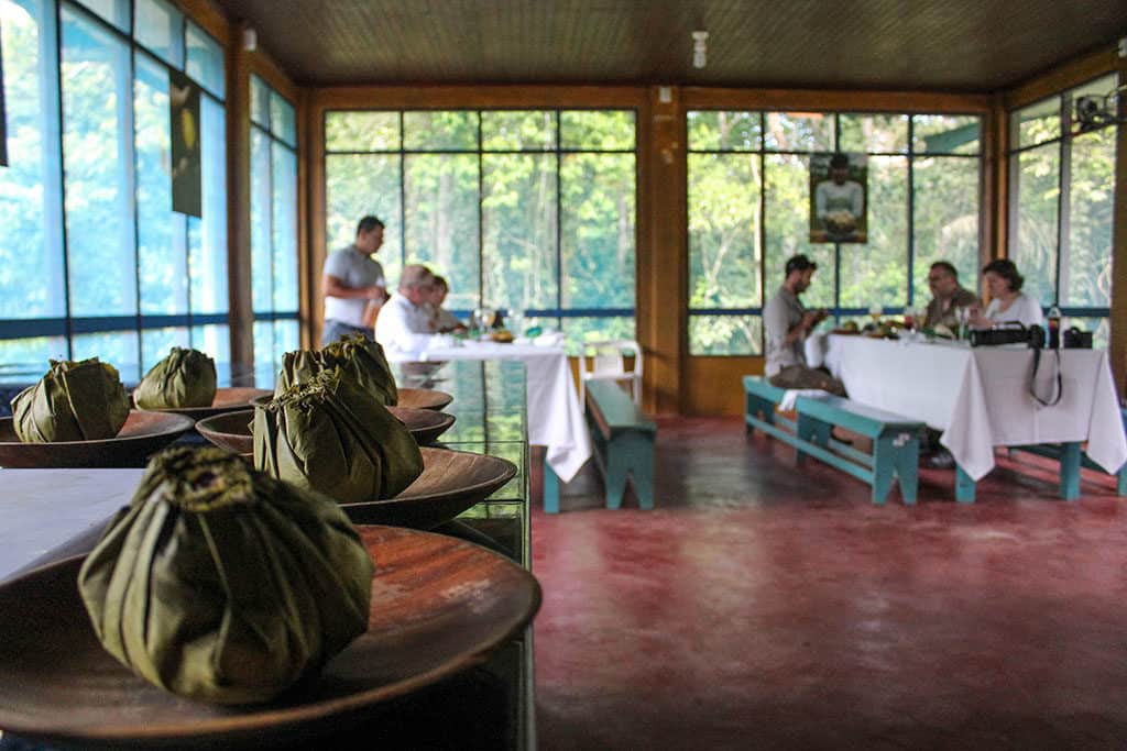 Juane Peru cuisine served at a table with travelers seated on benches in the background