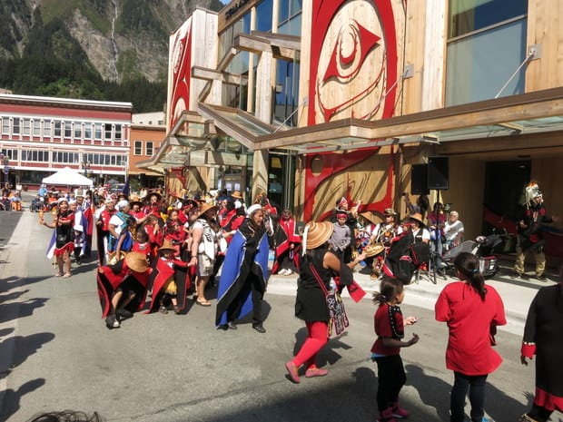 Native Tlingit tribe parade in front of the Cultural Center in an Alaskan port. 