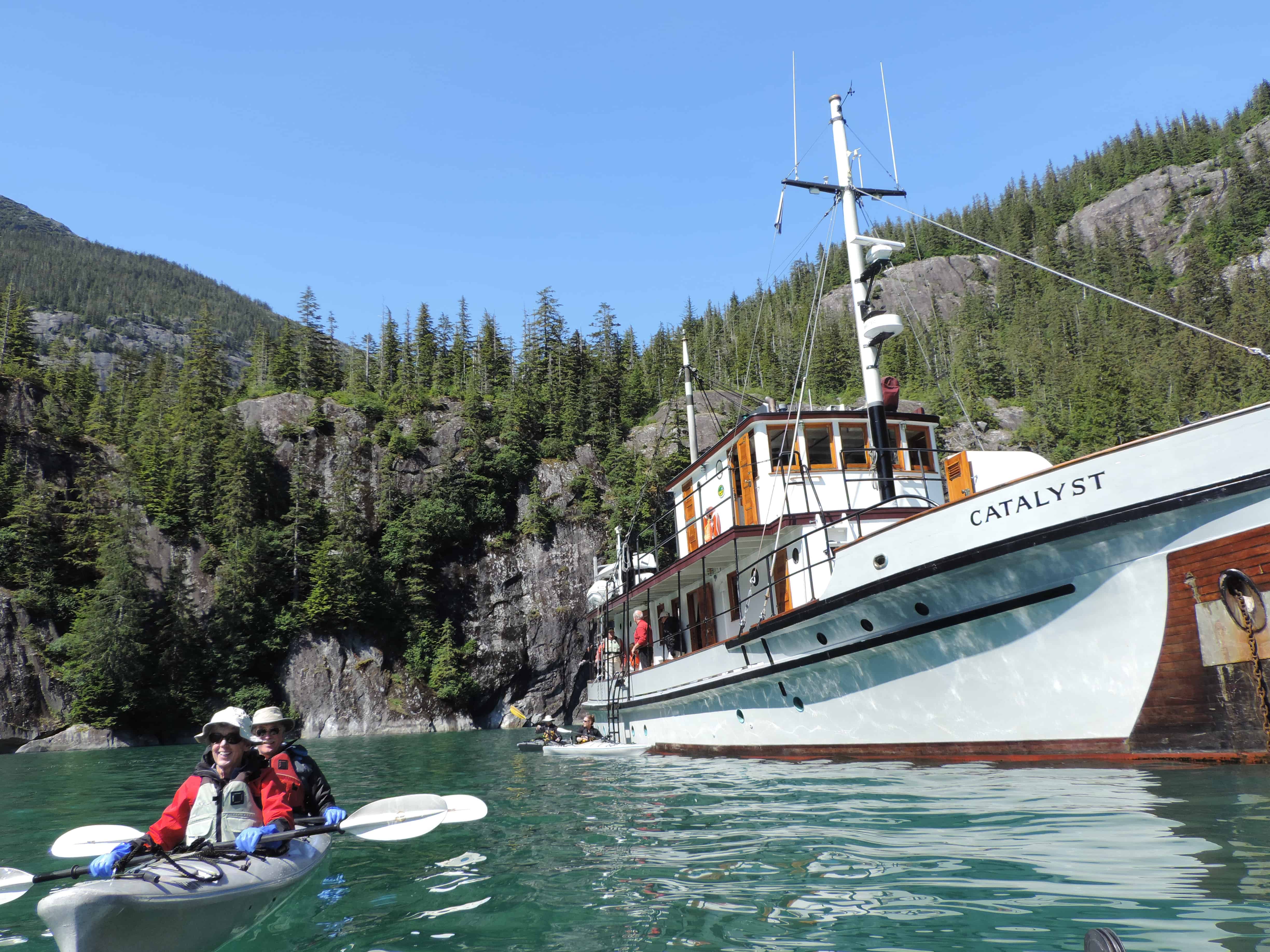 Guests kayaking straight from their small ship cruise in Alaska. 