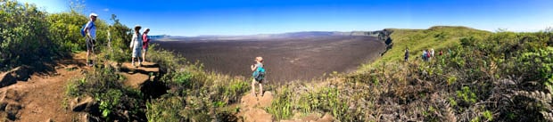 A group of hikers in the Galapagos walking along a trail on a land tour.