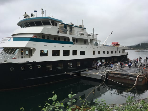 Small cruise ship docked in port in Alaska. 