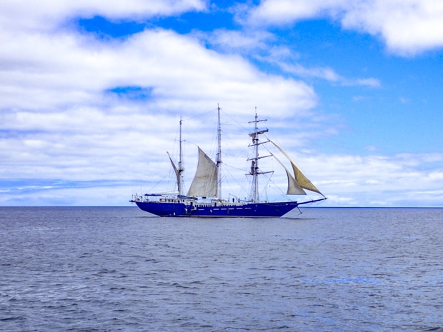 The small ship cruise Mary Anne with sails out and blowing in the wind.