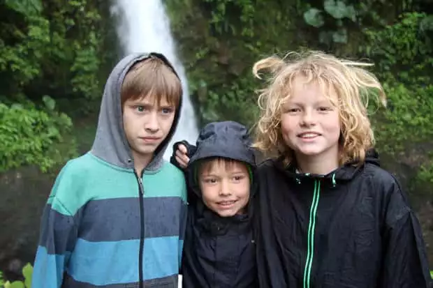 Children in front of a waterfall. 