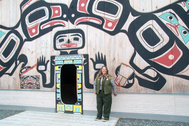 National Park employee standing in front of cultural interpretive center. 