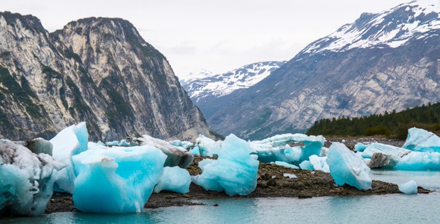 Icebergs and mountains seen from small ship in Alaska. 