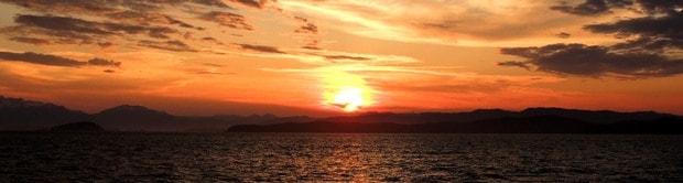 Red and orange sunset seen from a small ship cruise in Alaska. 