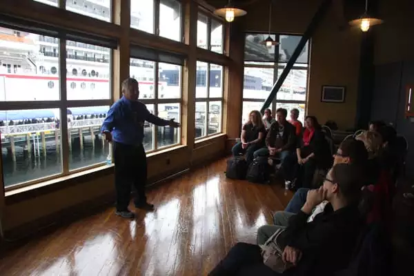 Native Tlingit tribe member welcoming tour group from small ship cruise in Ketchikan, Alaska. 