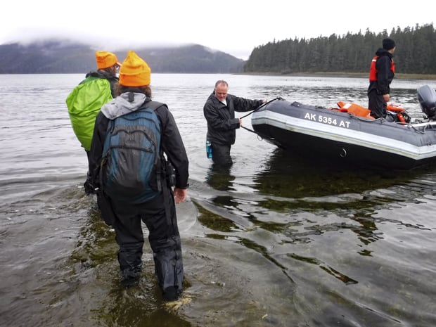 Guests returning from hike to their skiff waiting to take them back to their small ship in Alaska. 