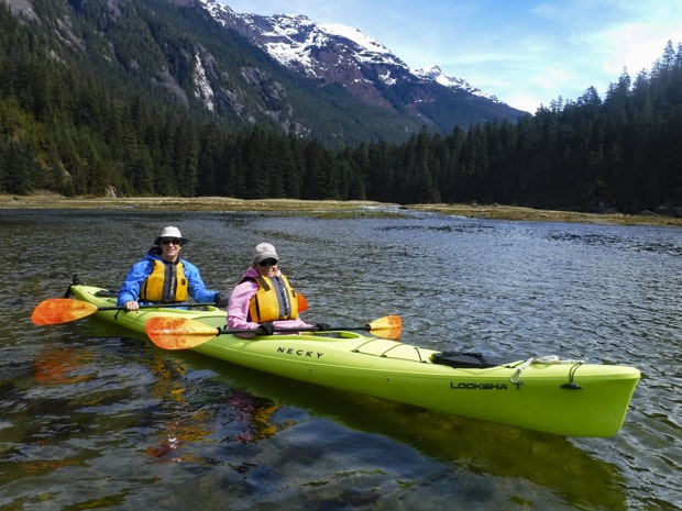 Guests from small ship cruise kayaking in Alaska. 