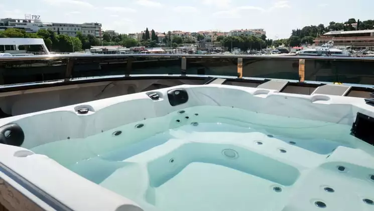 Large Jacuzzi on top deck of Aurelia deluxe yacht, as she sits in the harbor.