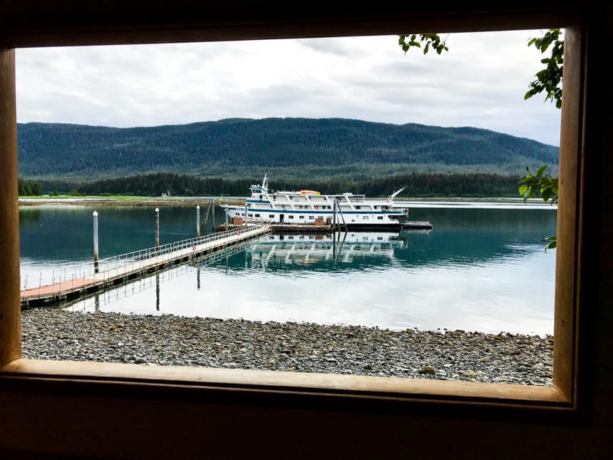 looking through a window at orca point lodge to see the admiralty dream alaska small ship docked in water