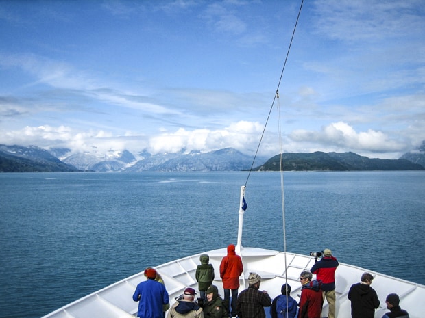 Passengers on bow of small ship cruising the Inside Passage of Alaska. 