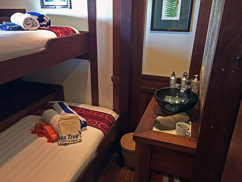 a cabin aboard ombak putih, two bunk beds with a sink in the same room
