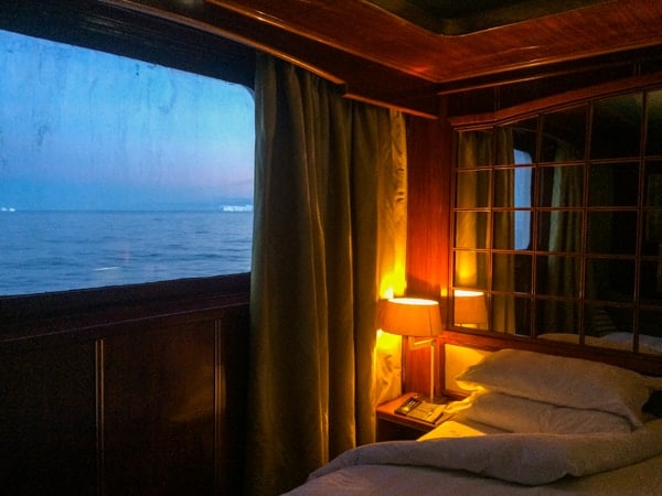 The sun goes down through the window of a suite cabin aboard hebridean sky polar expedition vessel