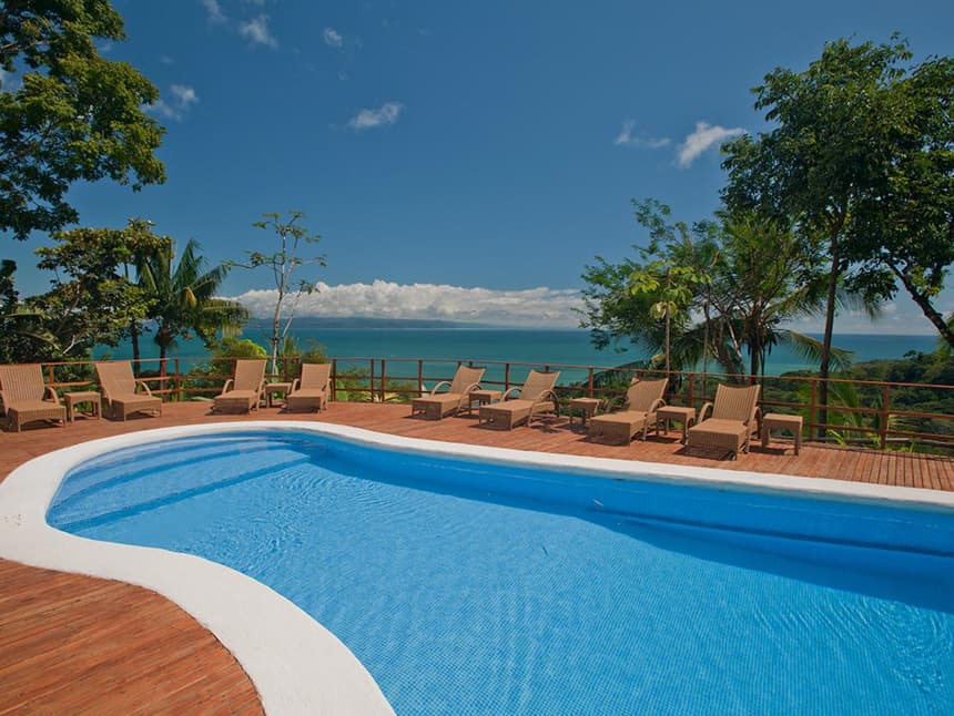 A view from the pool at Lapa Rios Eco Lodge Costa Rica, the crytal clear pool matches the blue sky and the ocean below it