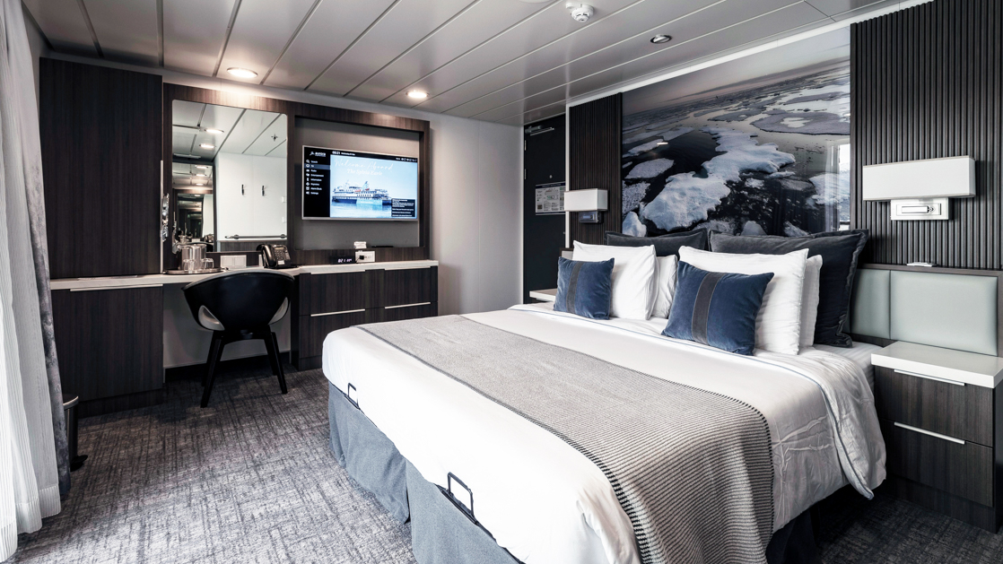 While cruising the polar waters stay warm and comfortable in the Superior Balcony Stateroom aboard the Sylvia Earle with large plush beds