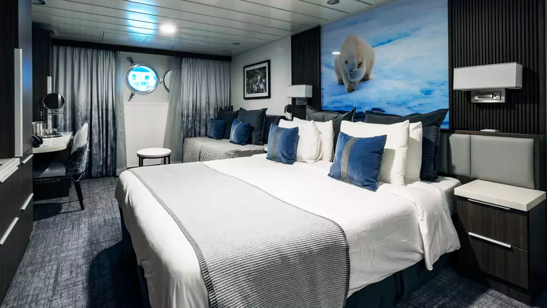 While cruising the polar waters stay warm and comfortable in the Triple Stateroom aboard the Sylvia Earle with large plush beds