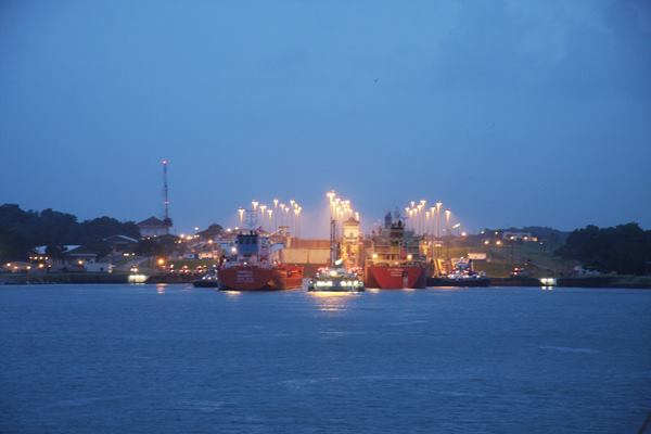 A view of the Panama Canal locks with 2 large cargo ships.