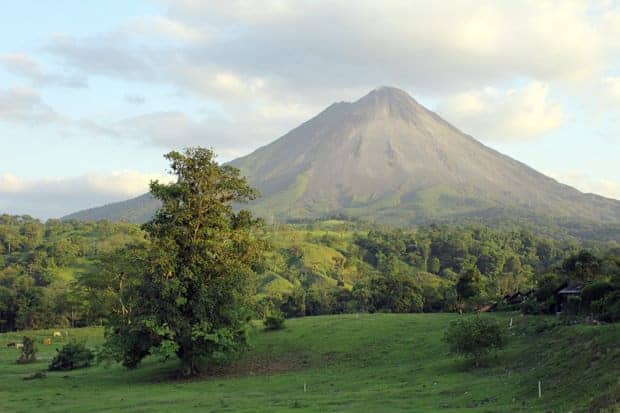 A scenic view of a volcano in Costa Rica with the rainforest at the base.