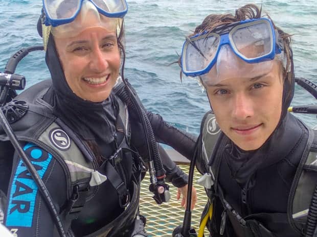 A mother and child about to SCUBA dive in the Great Barrier Reef