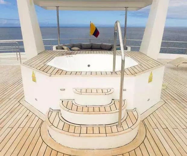 View of the stern of the boat with a hot tub and couch.