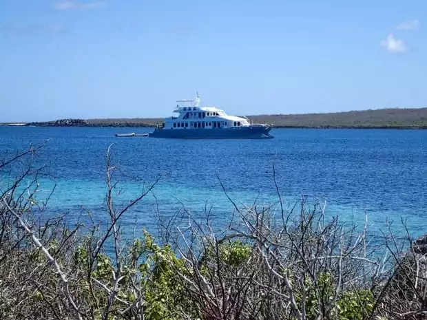 Small ship cruise catamaran Alya anchored off the coast in the Galapagos.