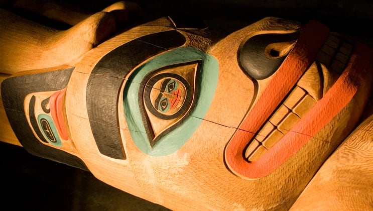 Detailed section of a totem pole as seen on the Ultimate Glacier Bay, Wilderness & Wildlife Alaska small ship cruise.