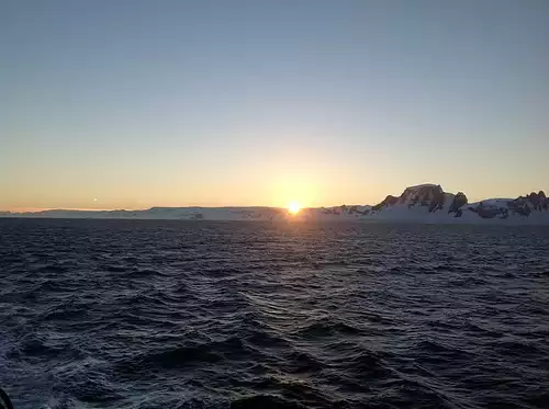 Sunset in Antarctica seen from a small ship cruise. 