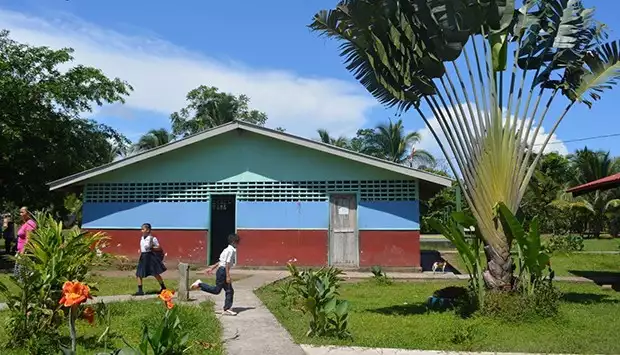 Children walking in front of the Laguna de Tortuguero School in Costa Rica. 