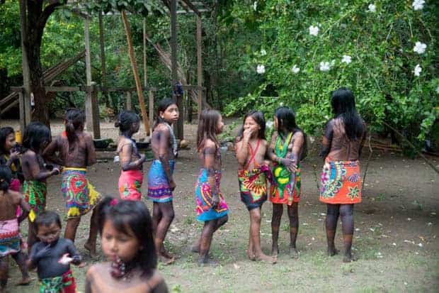 indigenous girls wearing bright garb in the costa rica jungle