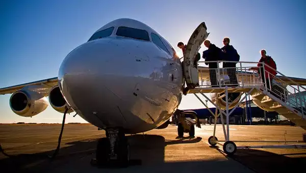 Guests board a plane from the tarmac to start a seamless Chile vacation.
