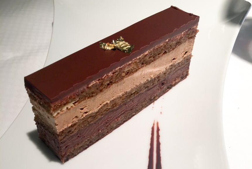 A piece of multi layered chocolate cake, served aboard Luxury small ship.