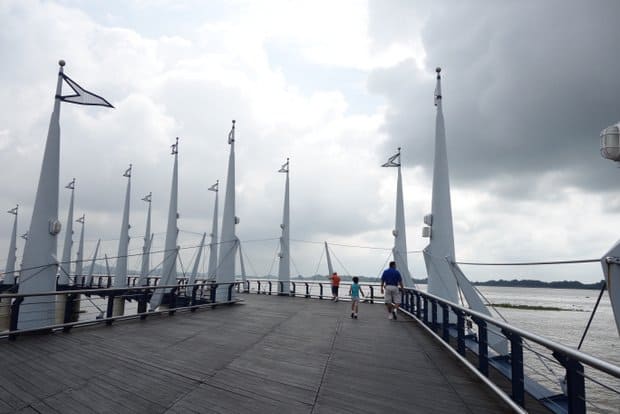 People walking on the Guayaquil malecon along the water in Ecuador.