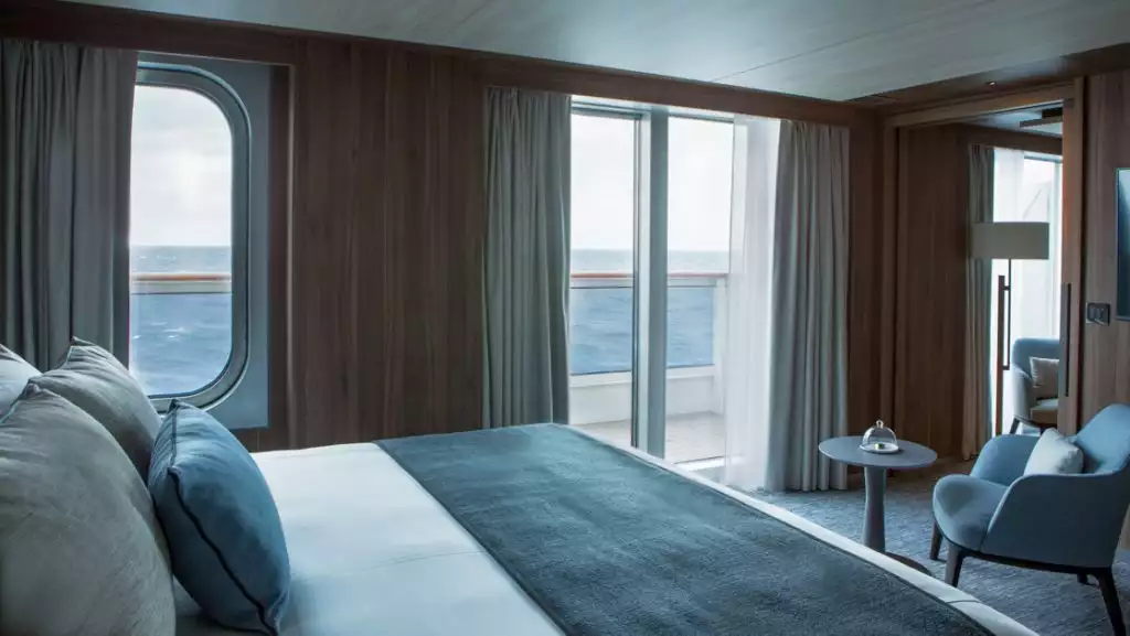 Prestige Suite bedroom with king bed aboard Le Commandant Charcot. Photo by: Gilles Trillard/Ponant