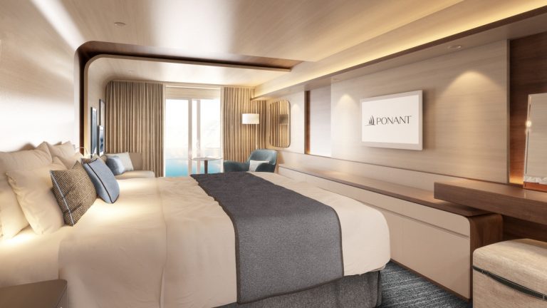 Rendering of cabin aboard Le Commandant Charcot ship, with beige & blue color theme, double bed, couch, TV & private balcony.