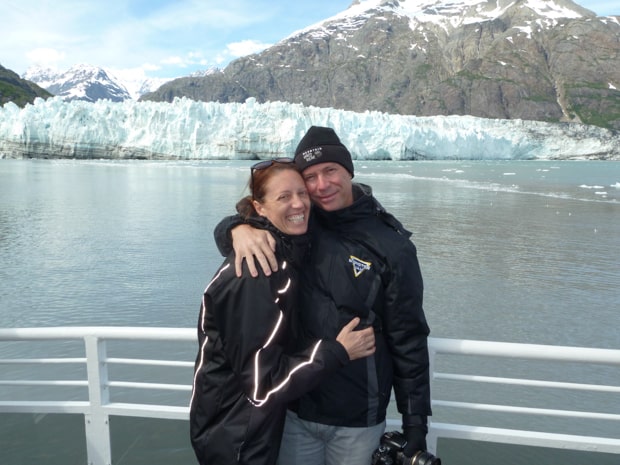 John's Hopkins tidewater glacier with happy Alaskan travelers on the deck of a day cruise.