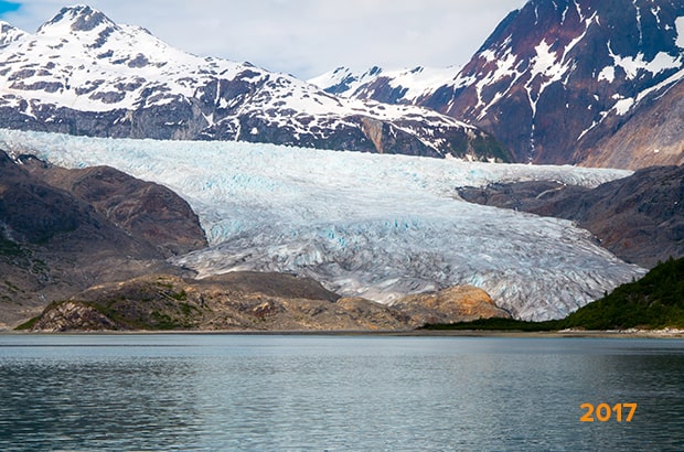 An Alaskan glacier with snow on it on a cloudy day