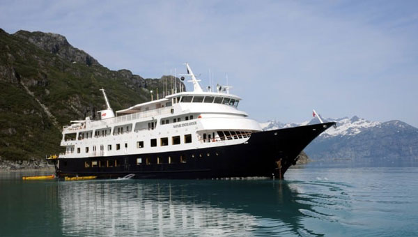 Safari Endeavour charter boat cruising on glassy Alaskan waters on a sunny day