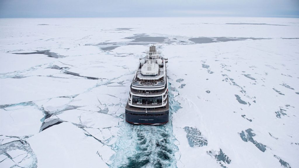 Aerial view of Le Commandant Charcot polar expedition ship cruising through ice during a Ross Sea expedition.