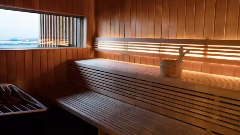Inside of wooden sauna with under-bench lighting & view window at the Fosshotel Myvatn.