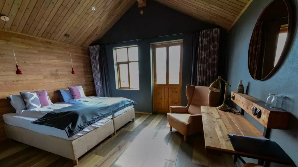 Room with double bed in modern Bakki guesthouse